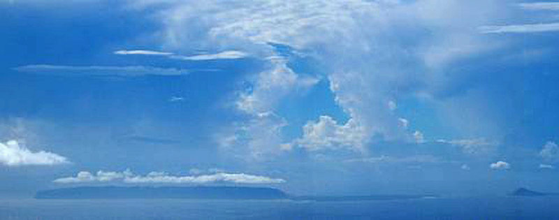 [Niʻihau, as viewed from Kauaʻi] With Lehua Islet on the right. Photo by Carole Hude.