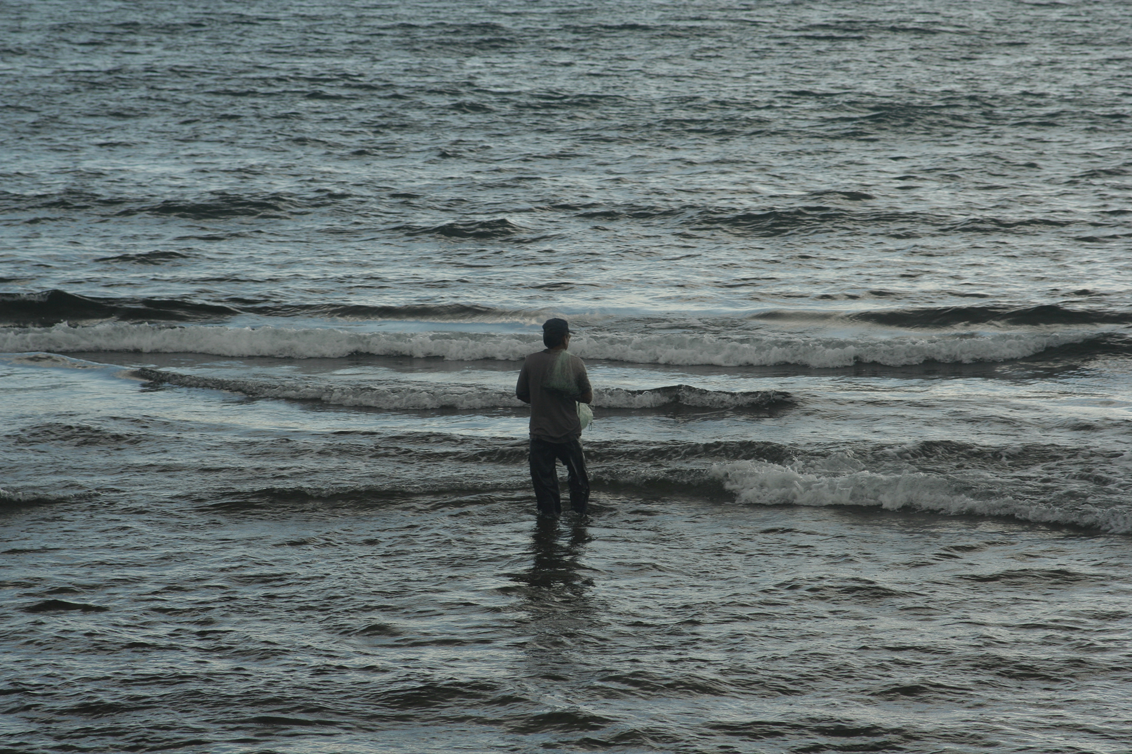 [Fisherman with net] Photo by Jeff Christiansen.