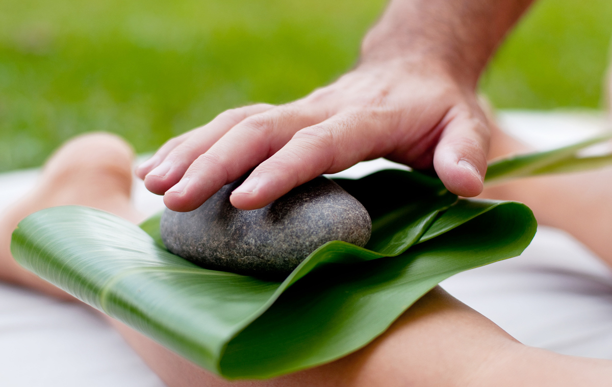 [Lomilomi with ti leaf and stone] Photo by Ruben Carillo.